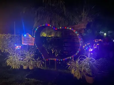 a heart light display in a garden at night at AsiaCamp - Chalet Sungai Sireh in Tanjung Karang