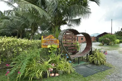 a sign in the shape of a heart next to a bench at AsiaCamp - Chalet Sungai Sireh in Tanjung Karang