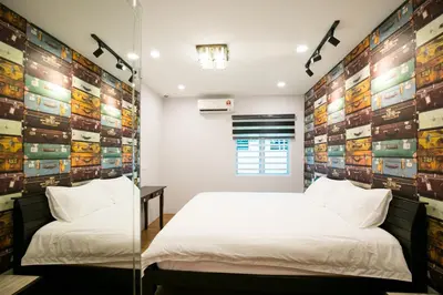 a bedroom with two beds and a glass wall at Canning 33 in Ipoh