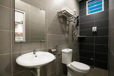 a bathroom with a toilet and a sink at Canning 33 in Ipoh