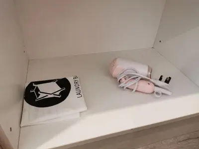 a box with a hair dryer and a book on a counter at TT Dorf Hotel Matang in Taiping
