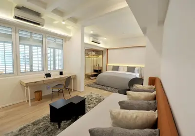 a bedroom with a bed and a desk and chairs at 88 Armenian in George Town