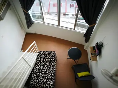 an attic room with a bed and a window at Comfort Zone @ The CEO Loft by Joal in George Town