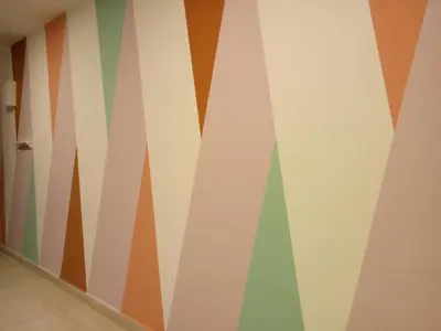 a room with a wall with colorful stripes at ICOLOR HOME & STAY CH1 in Tanah Rata