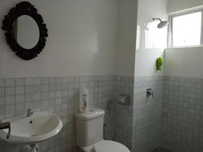 a bathroom with a toilet and a sink and a mirror at ICOLOR HOME & STAY CH1 in Tanah Rata
