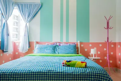 a bedroom with a bed with a toy on it at ICOLOR HOME & STAY CH1 in Tanah Rata