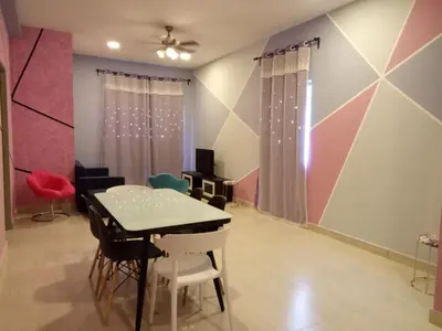 a dining room with a table and chairs at ICOLOR HOME & STAY CH2 in Tanah Rata