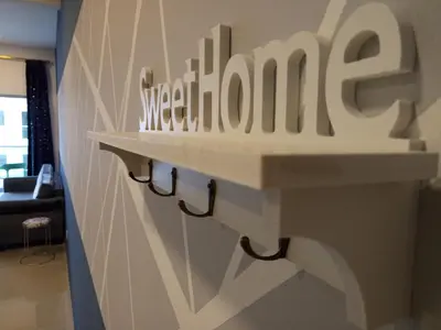 a wall with a sign that reads sydney at ICOLOR HOME & STAY CH3 in Tanah Rata