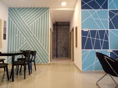 a dining room with blue and white walls and chairs at ICOLOR HOME & STAY CH3 in Tanah Rata