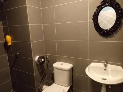 a bathroom with a toilet and a sink at ICOLOR HOME & STAY CH4 in Tanah Rata