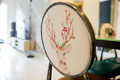 a mirror with a painting of a deer on it at ICOLOR HOME & STAY CH5 in Tanah Rata