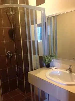 a bathroom with a sink and a shower at Teaz Apartment @ Iris House Resort in Cameron Highlands