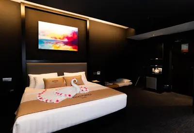 a bedroom with a bed with a swan on it at Artworks Hotel Ipoh in Ipoh