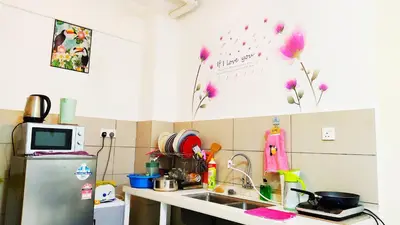 a kitchen with a sink and a refrigerator at Mevin Woodsbury Suite Butterworth Penang in Butterworth