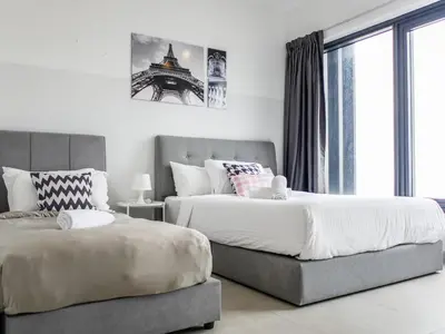 a bedroom with two beds and a large window at Casita 22, 218 Macalister Georgetown City & Seaview in George Town