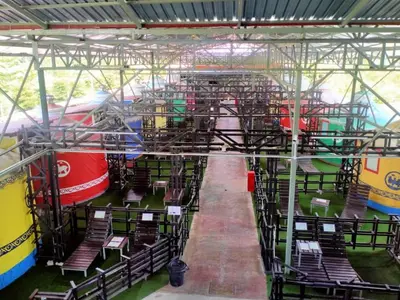 a group of chairs in a building with a train at Rick Resort Teluk Intan in Teluk Intan