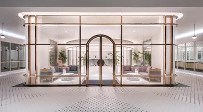 a lobby with glass doors and furniture in a building at The Prestige Hotel Penang, a Member of Design Hotels in George Town