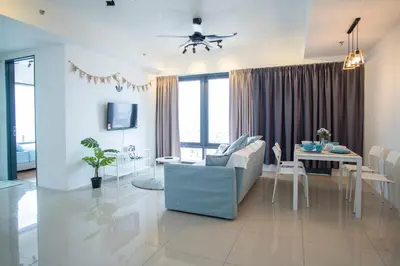 a living room with a blue couch and a table at Tropicana 218 MACALISTER in George Town