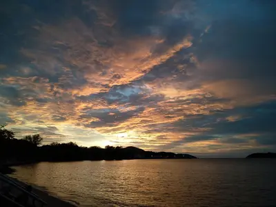 a sunset over a body of water at Desair Apartment By SCHT in Lumut