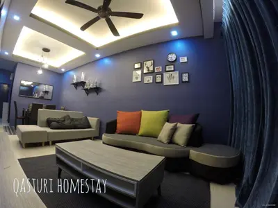 a living room with a couch and a ceiling fan at Qasturi Homestay Cameron in Cameron Highlands