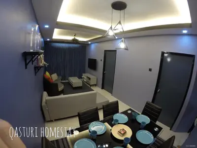 a room with a dining table and a living room at Qasturi Homestay Cameron in Cameron Highlands