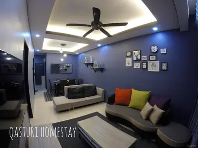 a living room with a ceiling fan and a couch at Qasturi Homestay Cameron in Cameron Highlands