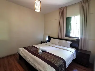 a bedroom with a bed with a teddy bear on it at 8 Boutique By The Sea in George Town