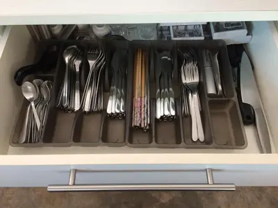 a drawer filled with utensils in a cabinet at Sarang by the brook in Kuala Kubu Baharu