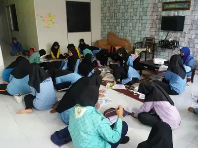 a group of girls sitting on the floor in a room at GERIK HOMESTAY in Gerik