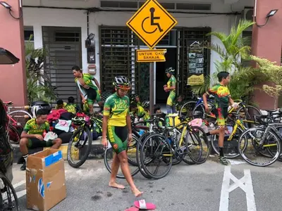 a group of bicyclists standing next to their bikes at GERIK HOMESTAY in Gerik