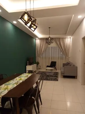 a dining room and living room with a table and chairs at NATURE @ FOREST CAMERON 15 in Tanah Rata