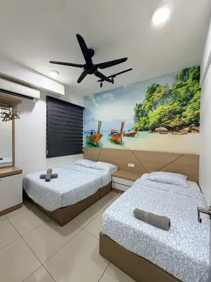 a bedroom with two beds and a painting on the wall at H2H - Summer Holidays Majestic Ipoh in Ipoh