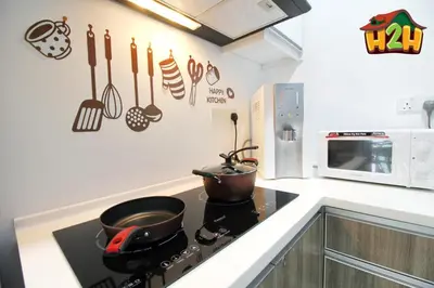 a kitchen with a stove with pots and pans on the wall at H2H - Summer Holidays Majestic Ipoh in Ipoh
