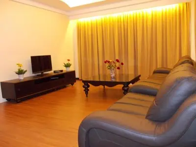 a living room with two couches and a television at Bali Style Apartment @ Imperial Court in Cameron Highlands