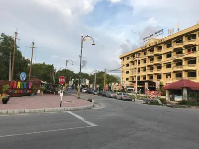 an empty street with a building and a stop sign at coralbay apartment pangkor island in Pangkor