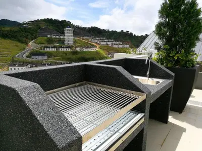 a balcony with a bench and a view of a city at DreamScape Studio @ Golden Hill Cameron in Cameron Highlands