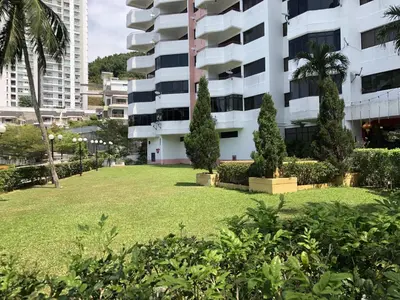 a park in front of a building at Susie's VIP Resort Seaview Suite at Sri Sayang in Batu Ferringhi