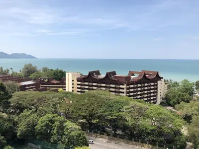 a large building on top of a hill with trees at Susie's VIP Resort Seaview Suite at Sri Sayang in Batu Ferringhi