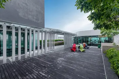 a patio with two chairs and a building at Cozy Home with Spectacular View in Bayan Lepas