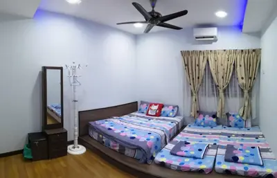 a bedroom with two beds and a ceiling fan at Sekinchan Paddy via Seaview Home \u9ad8\u697c \u770b\u6d77 \u7a3b\u7530 \u6c11\u5bbf in Sekincan