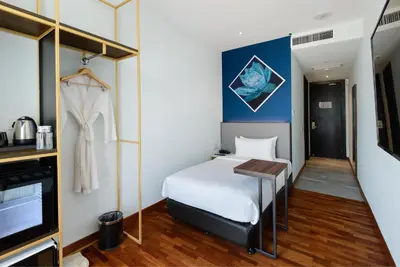 a hotel room with a bed and a tv at SAVV HOTEL in George Town