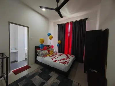 a bedroom with a bed with balloons and a window at MUSLIM 2 BED ROOM APARTMENT GOLDEN HILL in Brinchang