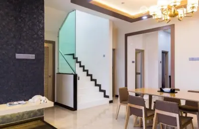 a dining room with a table and a staircase at Sekinchan Theme Design Penthouse 16-30Ppax \u4e3b\u9898\u9876\u5c42\u516c\u5bd3\u6c11\u5bbf in Sekincan