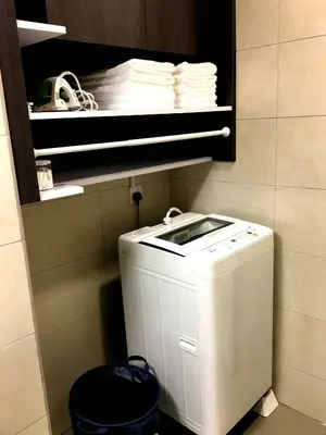 a kitchen with a washer and a pile of dishes at Excellent Location Octagon Studio at Palo 101 Ipoh in Ipoh