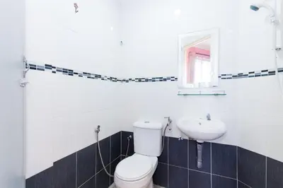 a bathroom with a toilet and a sink at Hotel O Comfort in Ipoh