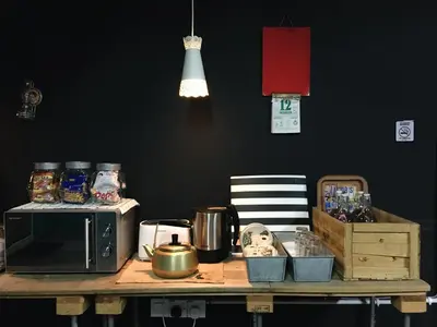 a wooden table with a microwave on top of it at Wogoxette Upstairs, A Private Kampung Stay In Cameron Highlands in Cameron Highlands