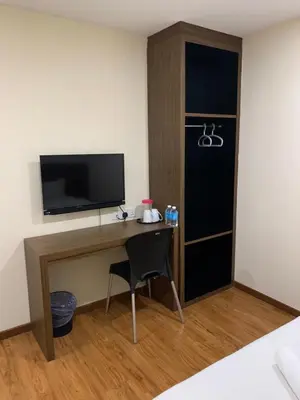 a room with a desk with a television and a chair at Mii Smile Hotel Penang in George Town