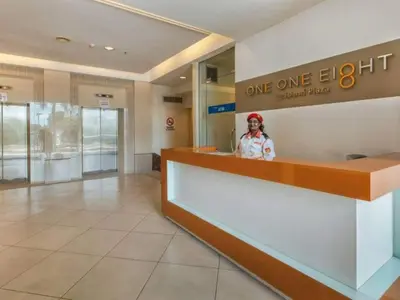 a woman standing behind a counter in a one light store at Selamat Datang @ 118 Island Plaza Superior Suite in Tanjong Tokong