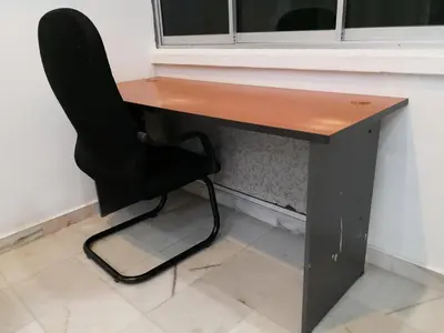 a black desk with a black chair next to a window at Hutan Melintang Homestay 12Pax Walk to 7Eleven KFC by willson in Hutan Melintang