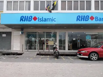 a motorcycle parked in a parking lot in front of a building at Hutan Melintang Homestay 12Pax Walk to 7Eleven KFC by willson in Hutan Melintang